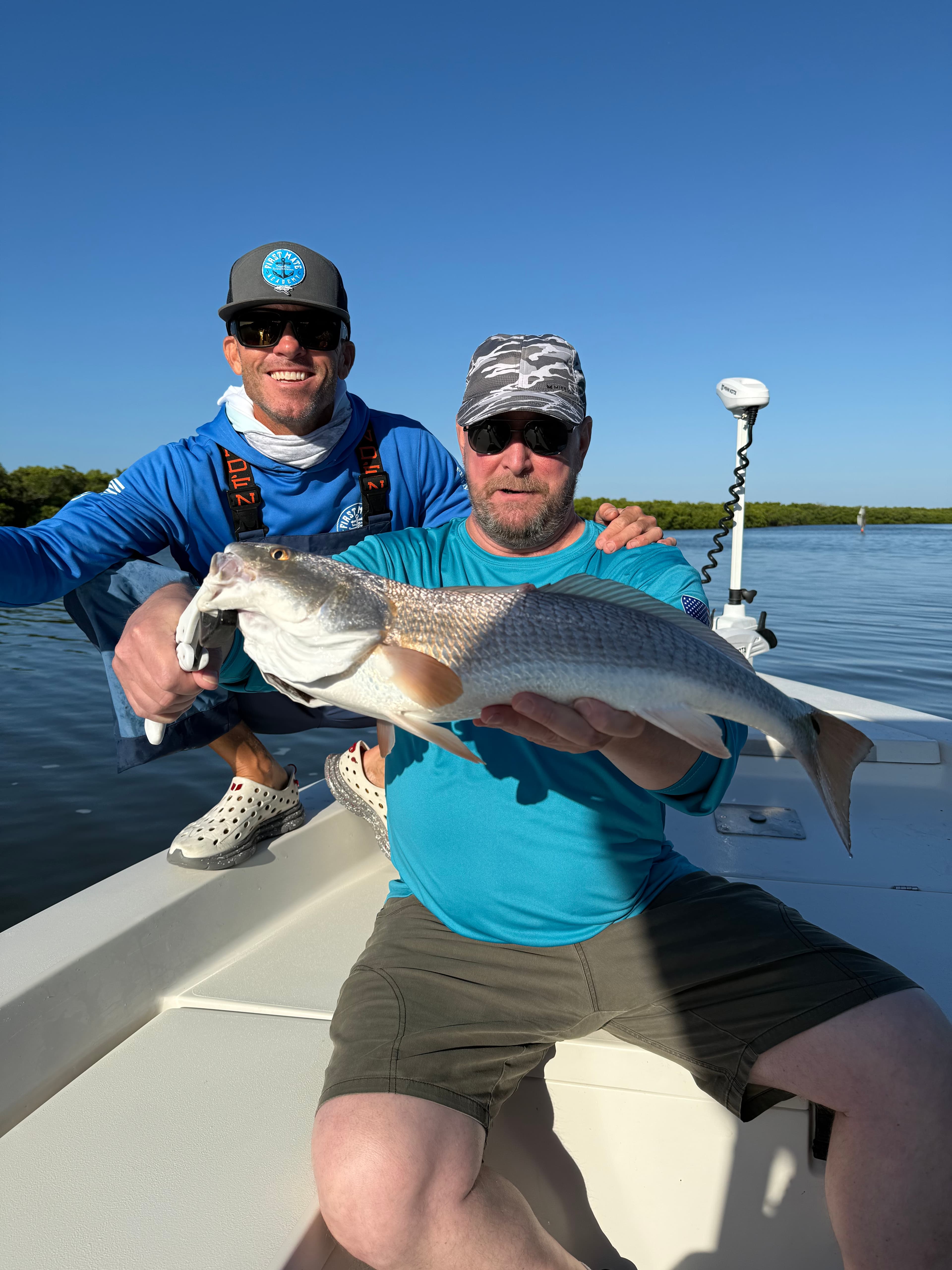 Angler holding a snook on an inshore fishing charter